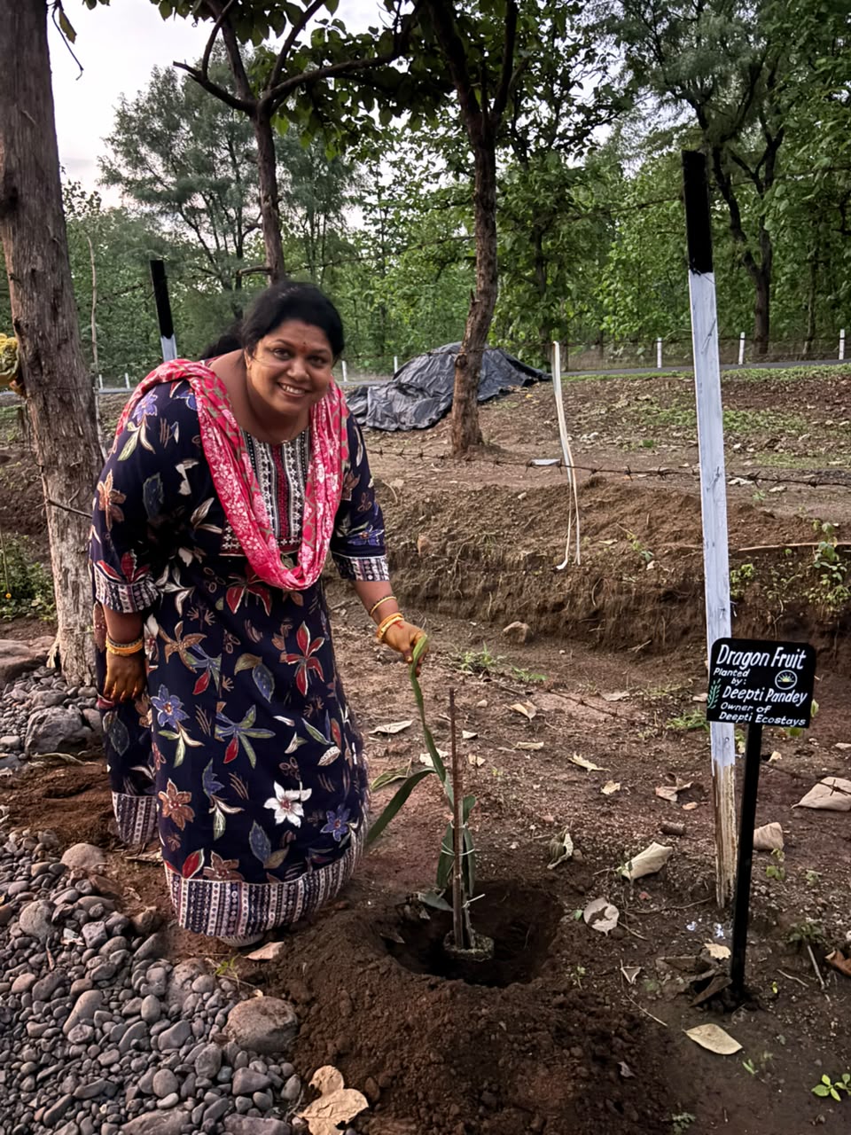 Deepti Pandey smiling while planting a dragon fruit sapling